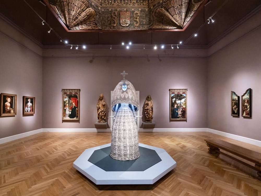 A Guo Pei couture gown installed among old master paintings in a Legion of Honor gallery.