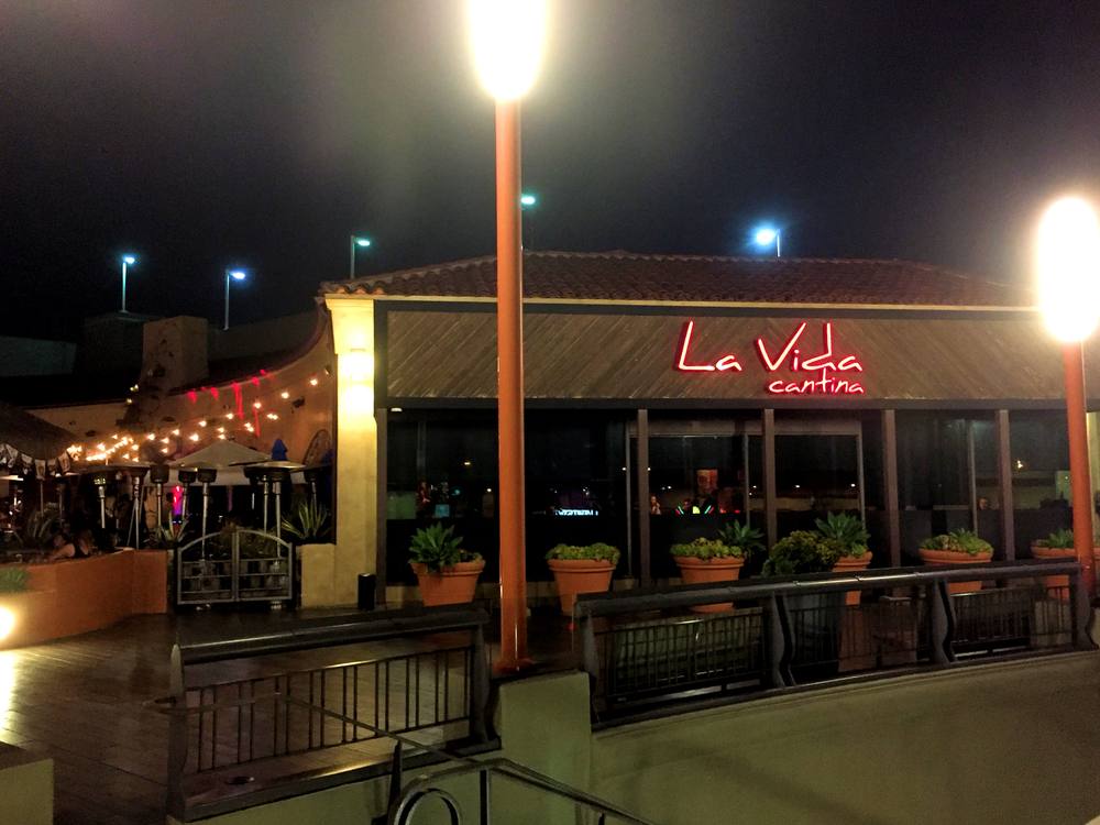La Vida Cantina exterior at night with string lights over the patio.