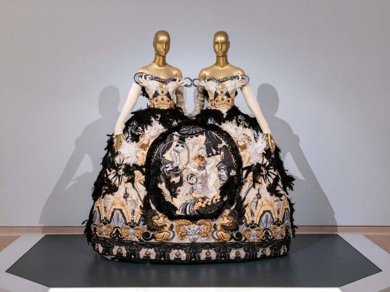 A Guo Pei couture piece on display in a gallery.